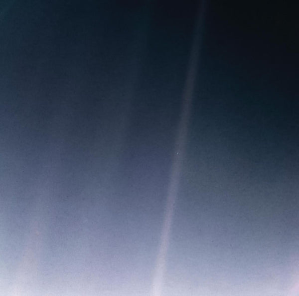 Pale Blue Dot — Earth as a single pixel in a sunbeam, photographed by Voyager 1. Credit: NASA/JPL-Caltech